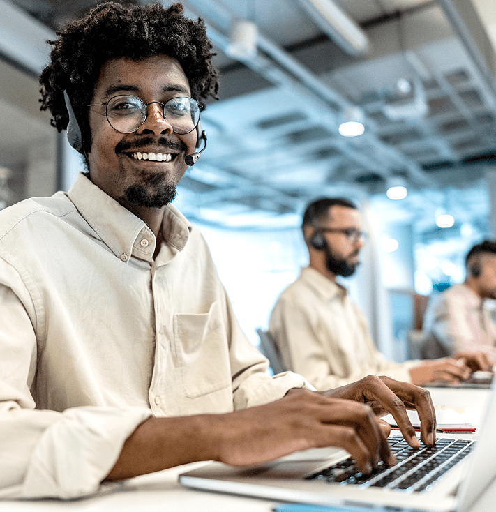 Man at computer wearing headset